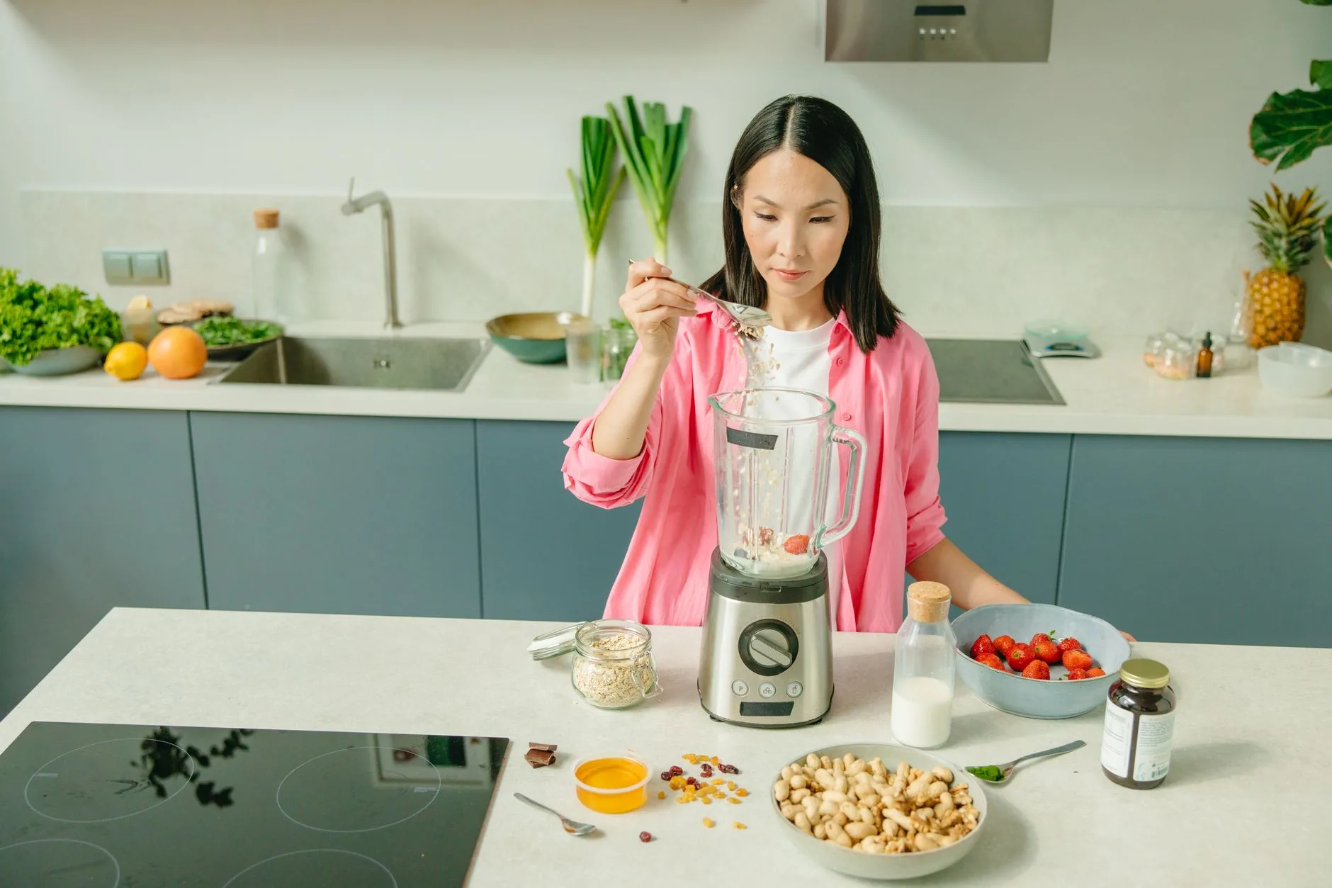 A bowl of Deliciously Ella Bircher Muesli on a rustic wooden table in a sunlit kitchen.